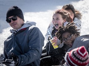 Serena Lake, center, screams at she descends an ice slide with friends from Pierre Elliot Trudeau school during the opening day of the 2017 Winterlude Festival at Jacques Cartier Park in Gatineau, Friday, February 3, 2017.