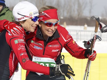 Skier Nathalie Godbout, right, celebrates winning the women's 27km classic style Gatineau Loppet cross-country ski race with second place finisher Louise Martineau, left, in Gatineau on Saturday, February 18, 2017.