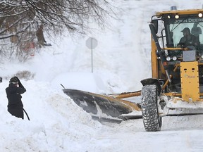 Ottawa residents on Blackburn Ave try and dig out of 30 cm of snow in Ottawa on Monday, Feb. 13, 2017.