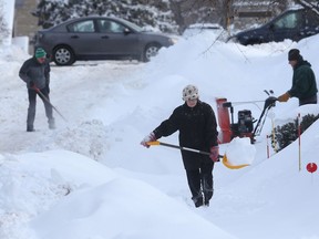 Ottawa residents on Bower Street try and dig out of 28 cm of snow in Ottawa on Monday Feb 13, 2017.