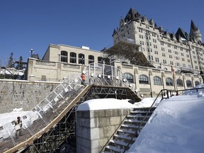 The Chateau Laurier is seen behind as workers continue construction on the site of the Red Bull Crashed Ice course at the Ottawa Lockstation of the Rideau Canal in mid-February.