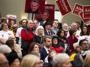 LIberal supporters crowded a hall to hear candidates speak.