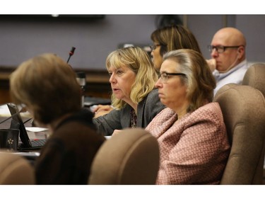 School board trustee Theresa Kavanagh, second from the left, asks a question to a delegation during the school board meeting.