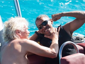 TOPSHOT - In a recent handout picture released by Virgin on February 7, 2017, former US president Barack Obama (R) is pictured during a kitesurfing session with British billionaire Richard Branson (L), off the coast of Moskito Island in the British Virgin Islands in the Caribbean. /