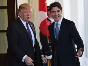 US President Donald Trump(L) greets Canada's Prime Minister Justin Trudeau upon arrival outside of the West Wing of the White House today in Washington, DC. /