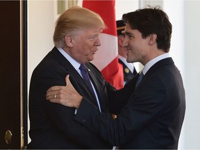 US President Donald Trump greets Prime Minister Justin Trudeau upon arrival outside of the West Wing of the White House on February 13, 2017.