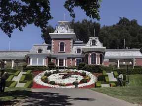FILE - In this July 2, 2009, file photo, workers standby at the train station at Neverland Ranch in Los Olivos, Calif. Michael Jackson&#039;s former home has been renamed Sycamore Valley Ranch. The Los Angeles Times reported March 1, 2017, that it had been relisted for sale for $67 million. (AP Photo/Carolyn Kaster, File)
