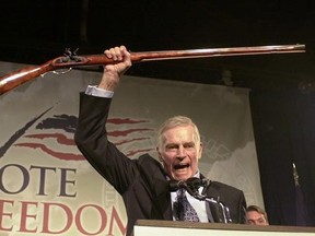 FILE - In this Oct. 21, 2002 file photo, National Rifle Association President Charlton Heston holds up a rifle as he addresses gun owners during a &ampquot;get-out-the-vote&ampquot; rally in Manchester, N.H. A Philadelphia judge&#039;s clash with the late actor has indirectly led to a U.S. appeals court decision to overturn a 1998 murder conviction. The judge met with the victim&#039;s family during the bench trial to discuss a blog they started that noted the &ampquot;Ben-Hur&ampquot; actor had called her soft on crime in an NRA speech