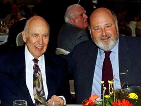 FILE - In this Aug. 18, 2000 file photo, Carl Reiner, left, appears with his son Rob Reiner at a Friars Club of California dinner in his honor in Beverly Hills, Calif. The Reiners are set to make history at the TCL Chinese Theatre, becoming the first father and son to jointly leave their cement footprints outside the Hollywood landmark on April 7, 2017. (AP Photo/Reed Saxon, File)