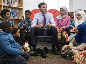 Canada&#039;s federal Finance Minister Bill Morneau takes part in the pre-budget ceremony of putting on new shoes at the Nelson Mandela Park Public School in Toronto, Monday March 20, 2017. THE CANADIAN PRESS/Mark Blinch