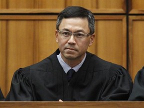 FILE - This Dec. 2015 file photo shows U.S. District Judge Derrick Watson in Honolulu. Watson is hearing arguments Wednesday, March 29, 2017, in Honolulu, on whether to extend his temporary order blocking President Donald Trump‚Äôs revised travel ban. But even if Watson doesn‚Äôt put the ban on hold until the state‚Äôs lawsuit is resolved, his temporary block would remain until he rules otherwise. (George Lee/The Star-Advertiser via AP, File)