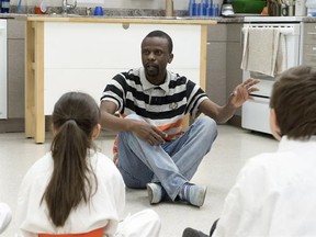 Tichaona Maredza talks to a karate class in Toronto on Friday March 24, 2017. Maredza shares a world music album nod with his nine-member group the Okavango African Orchestra for their self-titled release, by day he&#039;s a worker at the Stonegate Community Health Centre in Etobicoke, Ont. THE CANADIAN PRESS/Frank Gunn