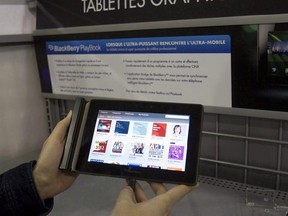 A customer looks at the Blackberry Playbook at a Best Buy store as the tablet went on sale in Canada in Montreal on April 19, 2011. BlackBerry may be taking another swing at the tablet market, said CEO John Chen. The move is part of the company&#039;s decision to expand its software licensing business after the former smartphone leader decided last year to stop making phones. THE CANADIAN PRESS/Ryan Remiorz