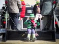 A bundled up parader waves to the crowd at Saturday's chilly St. Patrick's Day Parade on March 11, 2017. Ashley Fraser, Postmedia