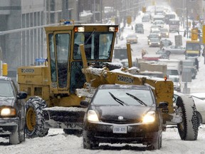 A grader makes its way through downtown during a snowstorm on Friday, Dec. 16, 2005. Postmedia files