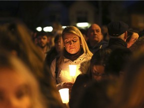 A woman joins hundreds of people for a candle lit vigil in West Belfast, Northern Ireland, Tuesday, March, 21, 2017, marking the death of Martin McGuinness.  Former Northern Ireland Deputy First Minister Martin McGuinness who was once a commander of the IRA (Irish Republican Army) who helped steer the militant group towards disarmament, then helped forge a power-sharing government with his Protestant opponents, died early Tuesday.