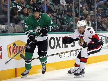 Dallas Stars' Ales Hemsky (83) of the Czech Republic and Ottawa Senators' Cody Ceci (5) compete for control of an airborne puck in the first period of an NHL hockey game in Dallas, Wednesday, March 8, 2017.