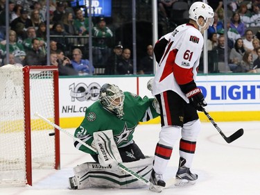 Dallas Stars' Antti Niemi (31) of Finland peers around Ottawa Senators' Mark Stone (61) as a shot by Viktor Stalberg, not shown, enters the net for a score in the second period of an NHL hockey game in Dallas, Wednesday, March 8, 2017.