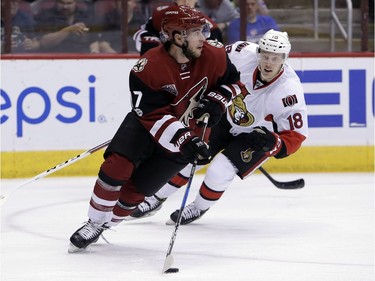 Arizona Coyotes defenseman Anthony DeAngelo (77) skates away from Ottawa Senators left wing Ryan Dzingel during the first period of an NHL hockey game, Thursday, March 9, 2017, in Glendale, Ariz.