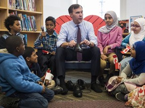 Canada's federal Finance Minister Bill Morneau takes part in the pre-budget ceremony of putting on new shoes at the Nelson Mandela Park Public School in Toronto, Monday March 20, 2017.
