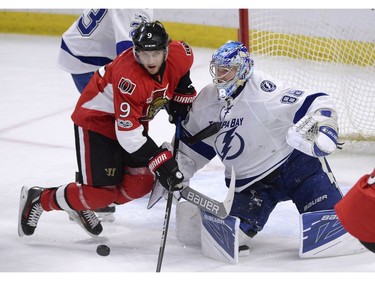Senators winger Bobby Ryan tries to gain control of the puck in front of Lightning goalie Andrei Vasilevskiy during the second period on Tuesday night.