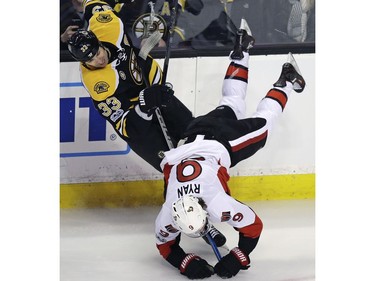 Ottawa Senators right wing Bobby Ryan (9) is upended as he collides with Boston Bruins defenseman Zdeno Chara (33) during the first period of an NHL hockey game in Boston, Tuesday, March 21, 2017.