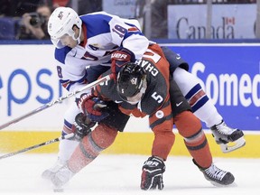 Colin White of the U.S. and Thomas Chabot of Canada get tangled during a battle for the puck in a world junior hockey championship game at Toronto on Dec. 31, 2016. Both players were drafted by the Senators in the first round in 2015.