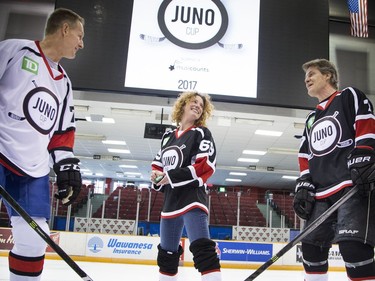 Canadian music celebrities and some hockey stars came together at TD Place arena Thursday March 30, 2017 for a practice a day before the big Juno Cup hockey game. L-R Gary Roberts, Kathleen Edwards and Jim Cuddy have a little laugh during a mock puck drop.