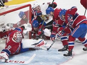 Senators winger Mark Stone, middle, has a good look, but can't get his stick on the puck in the scramble around Canadiens netminder Carey Price in the second period of Saturday's game.