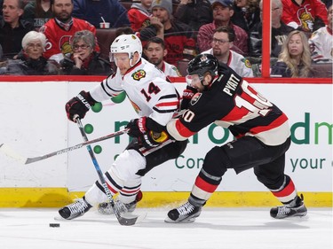 Tom Pyatt #10 of the Ottawa Senators uses his stick to slow down Richard Panik #14 of the Chicago Blackhawks at Canadian Tire Centre on March 16, 2017 in Ottawa.