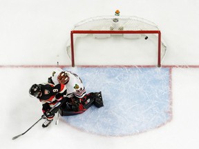 An overhead shot shows Senators winger Bobby Ryan providing a screen in front of Blackhawks netminder Scott Darling, allowing a shot by Kyle Turris (not shown) to enter the net for a goal by Kyle Turris (not shown) on a third-period power play during Thursday's game at Canadian Tire Centre.