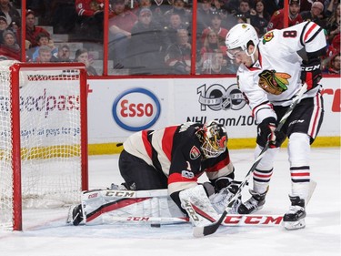OTTAWA, ON - MARCH 16: Mike Condon #1 of the Ottawa Senators makes a pad save against Nick Schmaltz #8 of the Chicago Blackhawks at Canadian Tire Centre on March 16, 2017 in Ottawa, Ontario, Canada.