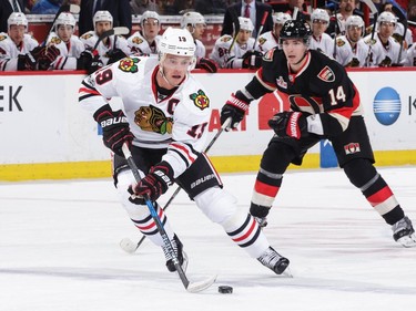 OTTAWA, ON - MARCH 16: Jonathan Toews #19 of the Chicago Blackhawks stickhandles the puck against Alexandre Burrows #14 of the Ottawa Senators at Canadian Tire Centre on March 16, 2017 in Ottawa, Ontario, Canada.
