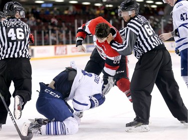 Chris Martenet takes a punch at Michael McLeod in the second period as the Ottawa 67's take on the Mississauga Steelheads in Game 4 of Ontario Hockey League playoff action at TD Place Arena.