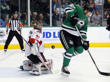 Ottawa Senators goalie Craig Anderson (41) defends against a shot that deflected off Dallas Stars' Cody Eakin (20) during the first period of an NHL hockey game in Dallas, Wednesday, March 8, 2017.