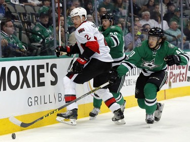 Ottawa Senators' Dion Phaneuf (2) works against Dallas Stars' Cody Eakin (20) and Remi Elie (40) to gain control of the puck in the first period of an NHL hockey game in Dallas, Wednesday, March 8, 2017.