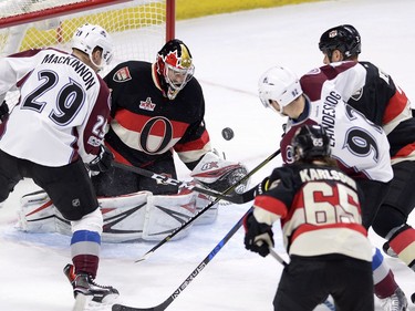 Ottawa Senators goalie Craig Anderson (41) keeps his eye on the puck against Colorado Avalanche Nathan MacKinnon (29) and Gabriel Landeskog (92) during second period NHL hockey action in Ottawa, Thursday, March 2, 2017.