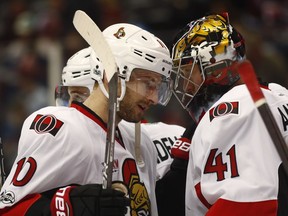 Senators forward Tom Pyatt, left, celebrates with goalie Craig Anderson, who set a franchise record of 147 victories by a goalie with Saturday's win over the Avalanche.