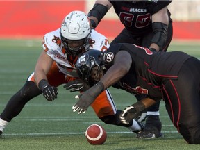 J'Michael Deane beats B.C.'s Craig Roh to the football to recover a fumble during the Redblacks' game at TD Place stadium on July 4, 2015.