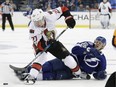 Curtis Lazar gets pulled down by Lightning defenceman Jake Dotchin during the third period of the Senators' game in Tampa on Feb. 2.