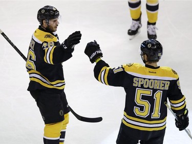 Boston Bruins center David Krejci, left, is congratulated by Ryan Spooner (51) after his goal against the Ottawa Senators during the first period of an NHL hockey game in Boston, Tuesday, March 21, 2017.