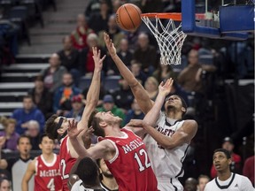 Ravens forward Eddie Ekiyor, second from right, battles for a rebound the Redmen's François Bourque, second from left, and Noak Daoust, centre, during the first half of Saturday's game in Halifax.