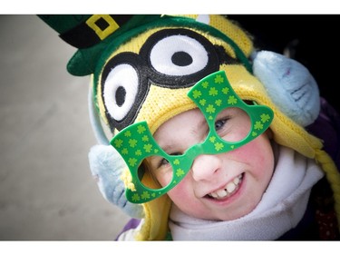 Eight year old Maddie Sullivan braved the cold to watch the 35th Annual St. Patrick's Parade took Saturday March 11, 2017.   Ashley Fraser/Postmedia