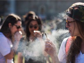 This file photo taken on April 20, 2016 shows a woman smoking during a rally to celebrate National Marijuana Day on Parliament Hill in Ottawa.