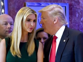 This file photo taken on Jan. 11 shows Donald Trump talking to his daughter Ivanka during a press conference at Trump Tower in New York.