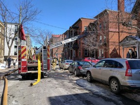 Firefighters at work at a two-alarm fire on Cooper Street Saturday, March 18.