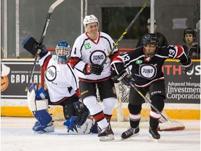 Goalie Matthew Barber looks on as Chris Phillips and Aaron Pritchett have a laugh as hockey and music join forces for charity in the  2017 JUNO Cup.