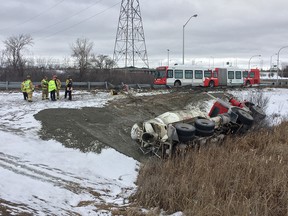 Firefighters at the scene of a crash Tuesday in which a cement truck ended up on its side iin the ditch near Highway 174 and Blair Road