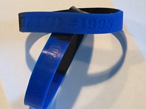 Ottawa police officers have purchased wristbands expressing solidarity with an officer accused of manslaughter in the death of Abdirahman Abdi, which bear the words 'united we stand,' 'divided we fall' and the number 1998, which is Const. Daniel Montsion's badge number.