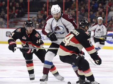 Colorado Avalanche John Mitchell (7) tries to make his way past Ottawa Senators Alexandre Burrows (14) and Mark Borowiecki (74) during first period NHL hockey action in Ottawa, Thursday, March 2, 2017.